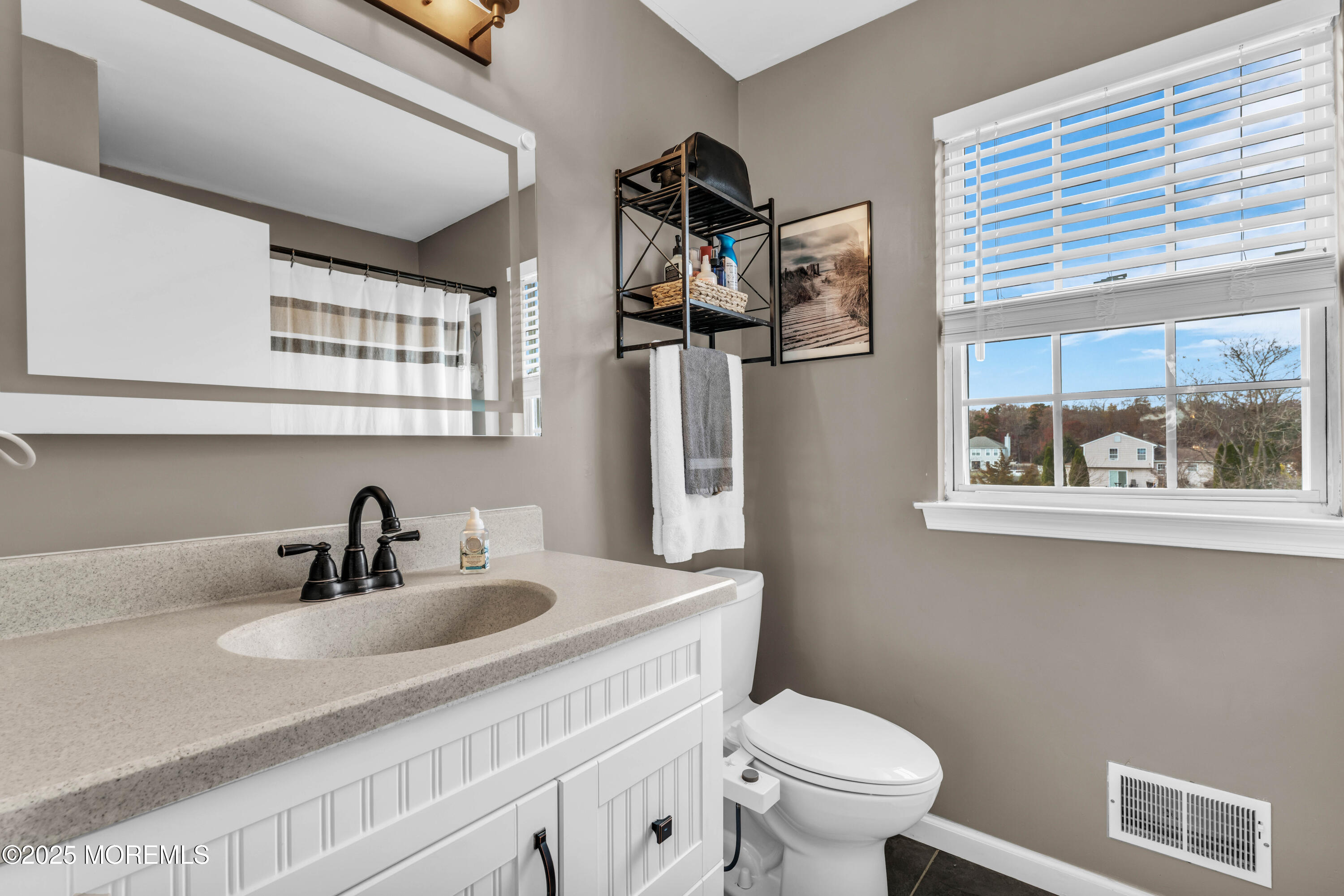 6 Hummingbird Way Jackson, NJ 08527 - Photo 25 of 39 a bathroom with a toilet a sink and mirror