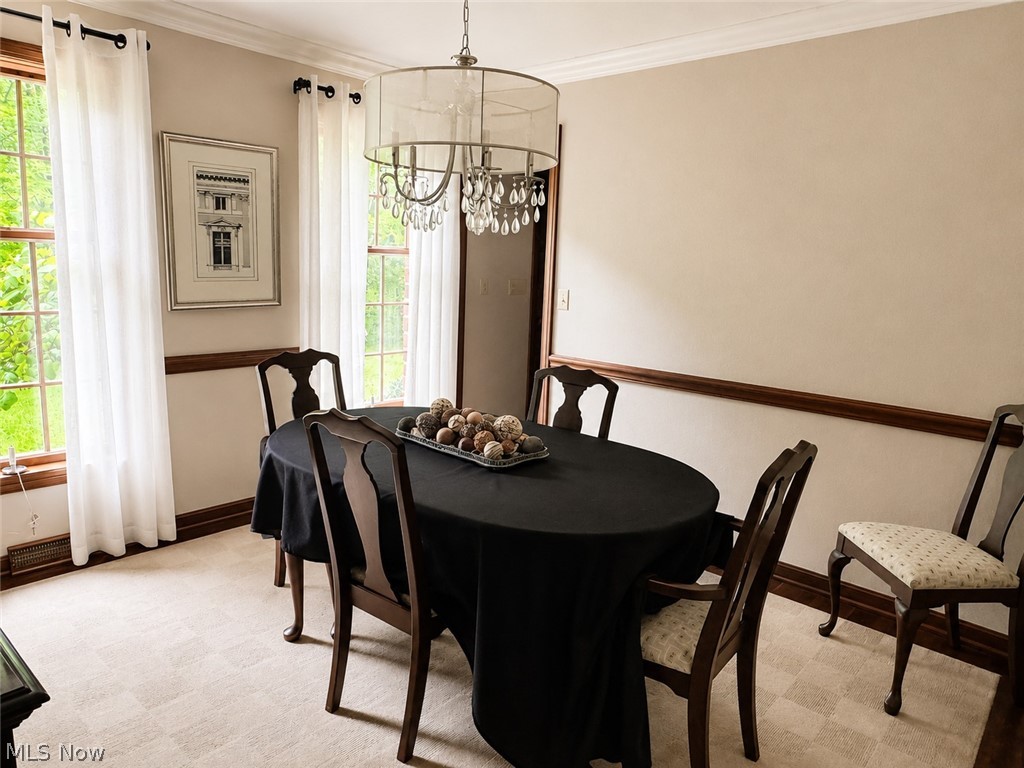 6155 Gibson Road Canfield, OH 44406 - Photo 14 of 43 Dining area featuring light-toned walls, crown molding, and wood-finish chair rail