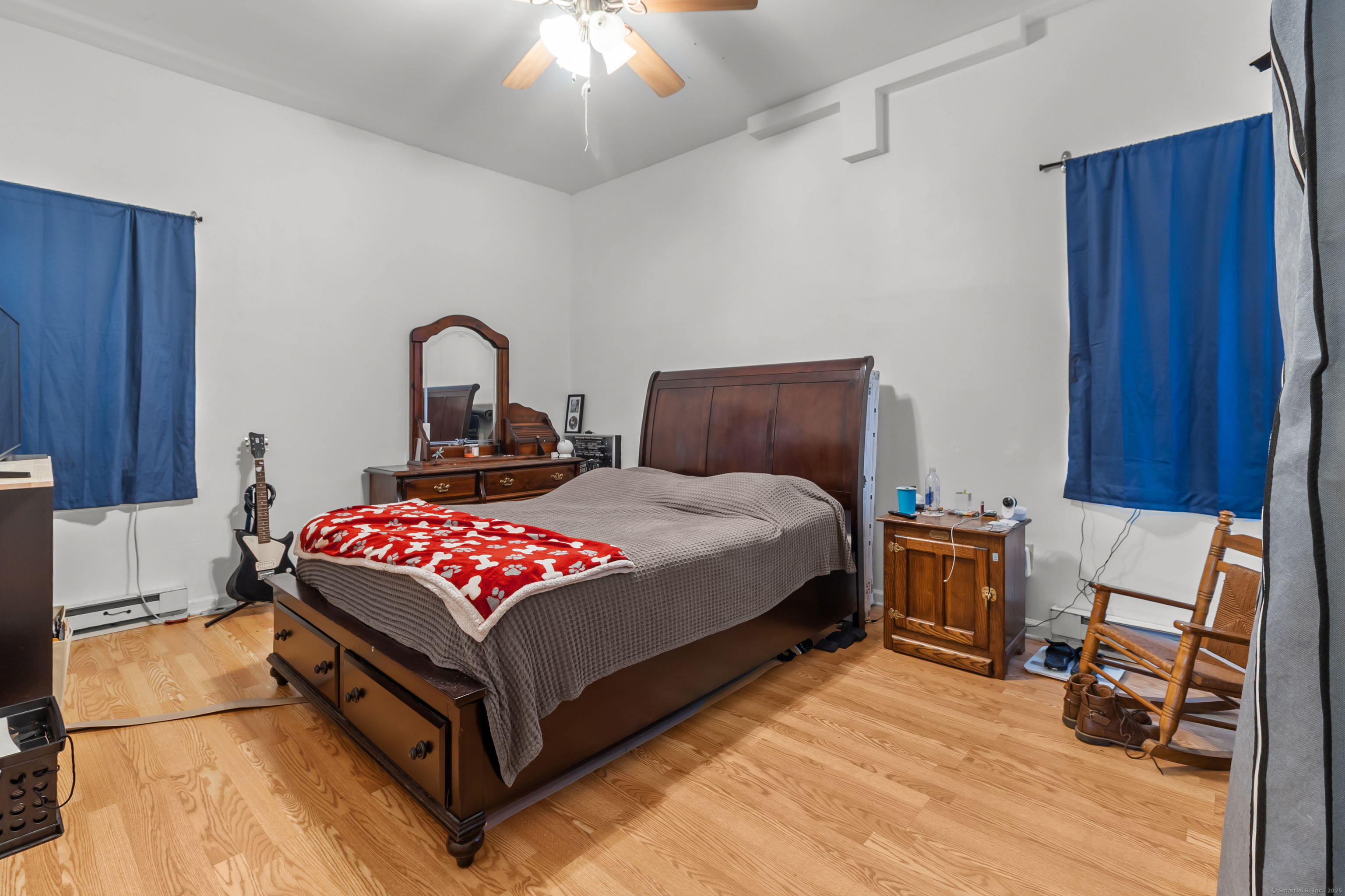 136 Washington Street Norwich, CT 06360 - Photo 11 of 40 a bedroom with a bed and wooden floor