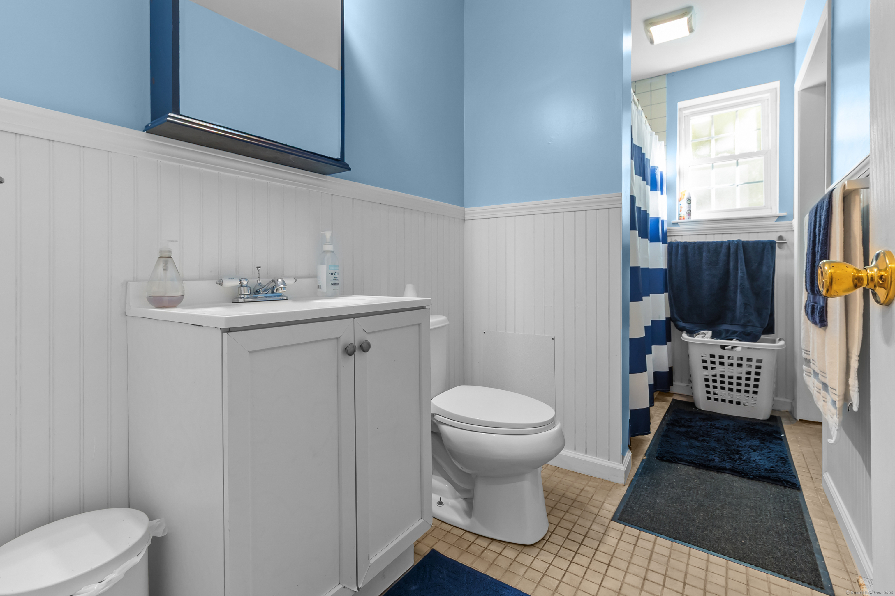 136 Washington Street Norwich, CT 06360 - Photo 12 of 40 a bathroom with a toilet sink and mirror