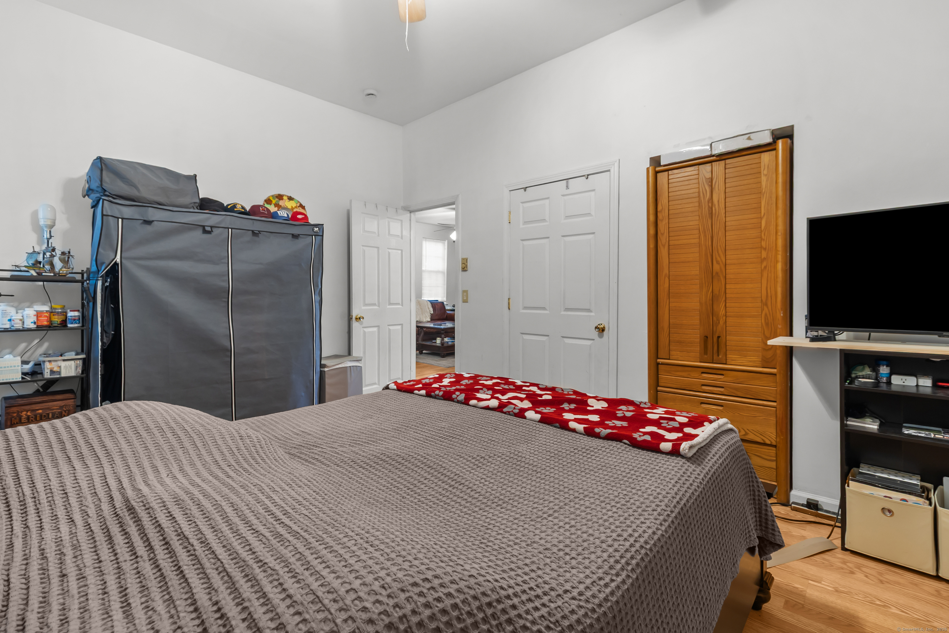 136 Washington Street Norwich, CT 06360 - Photo 14 of 40 a bedroom with a bed and a flat screen tv