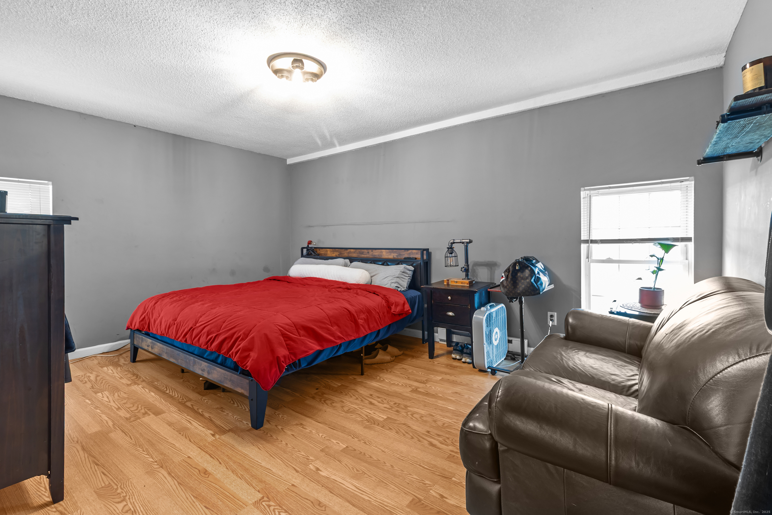 136 Washington Street Norwich, CT 06360 - Photo 21 of 40 a spacious bedroom with a bed and a couch