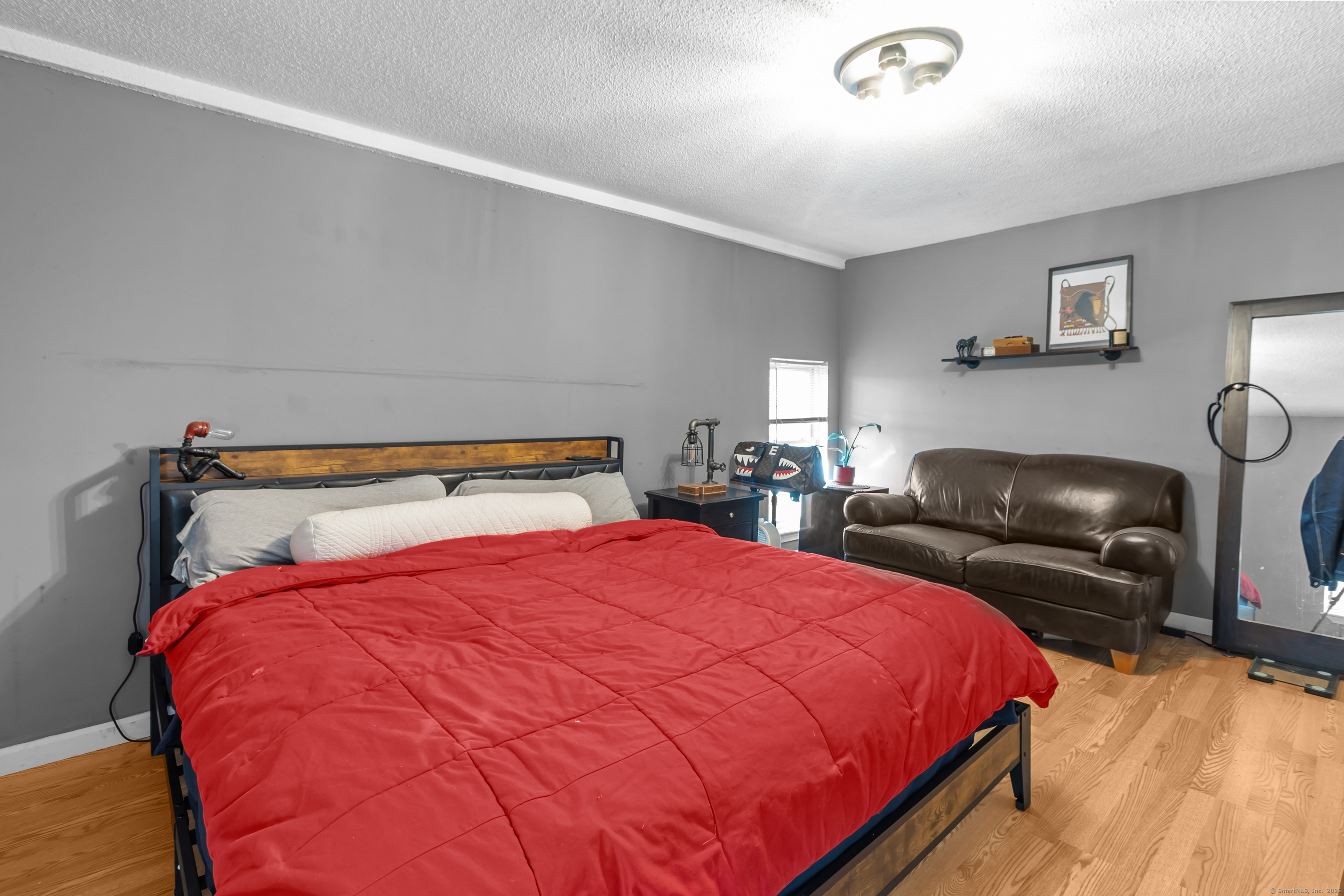 136 Washington Street Norwich, CT 06360 - Photo 22 of 40 a bedroom with a bed and window