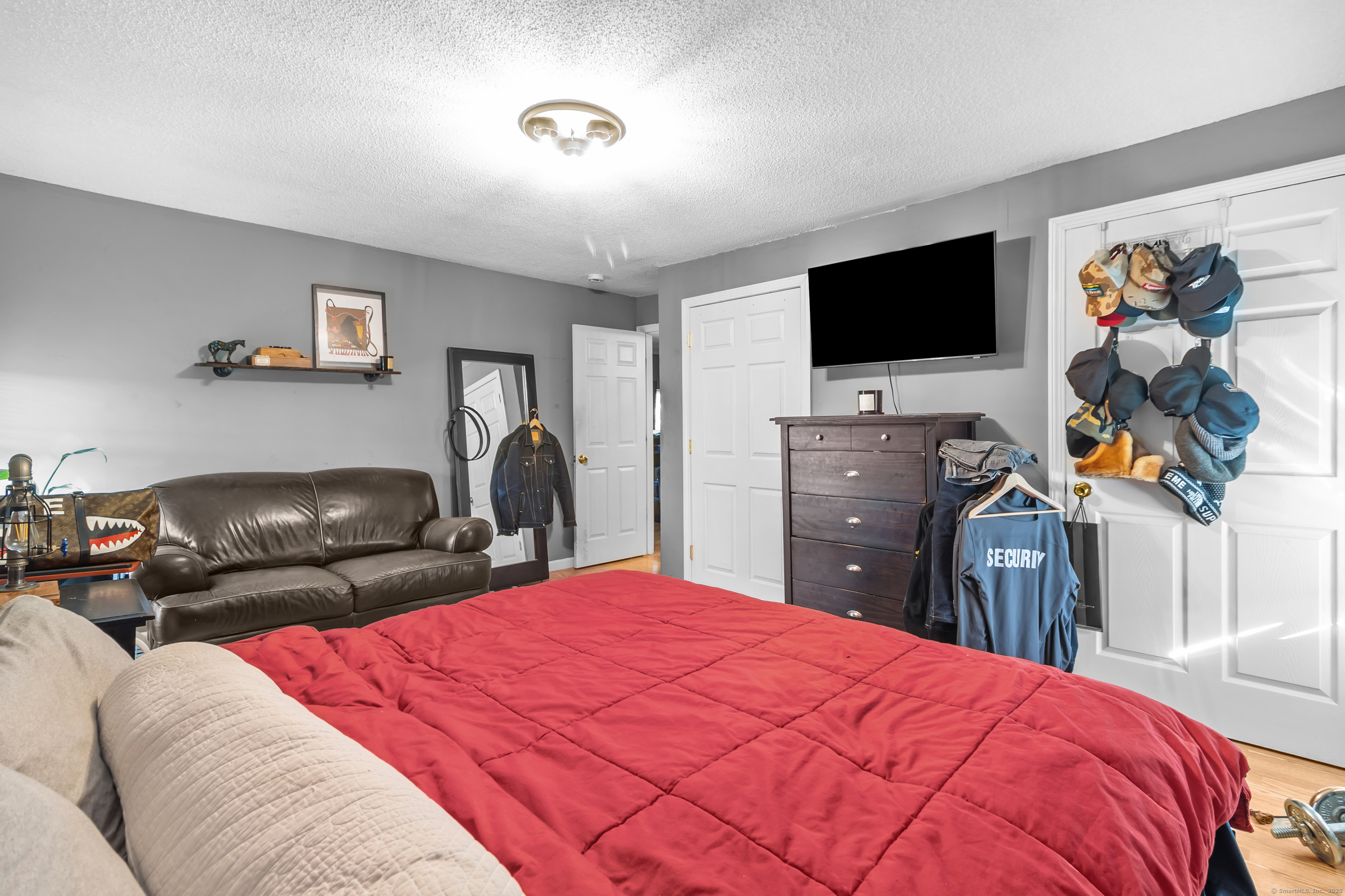 136 Washington Street Norwich, CT 06360 - Photo 23 of 40 a bedroom with a bed and a flat screen tv