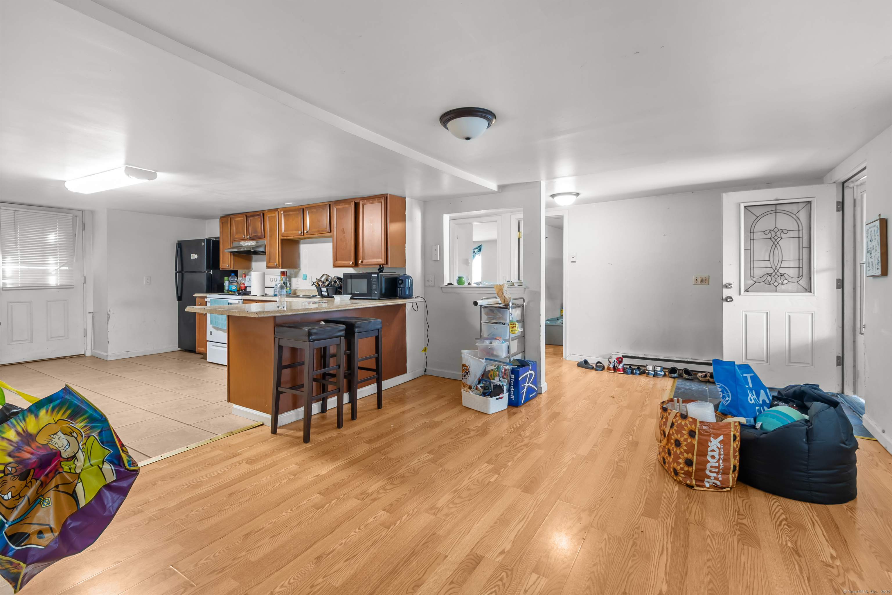 136 Washington Street Norwich, CT 06360 - Photo 28 of 40 a living room with furniture and a wooden floor