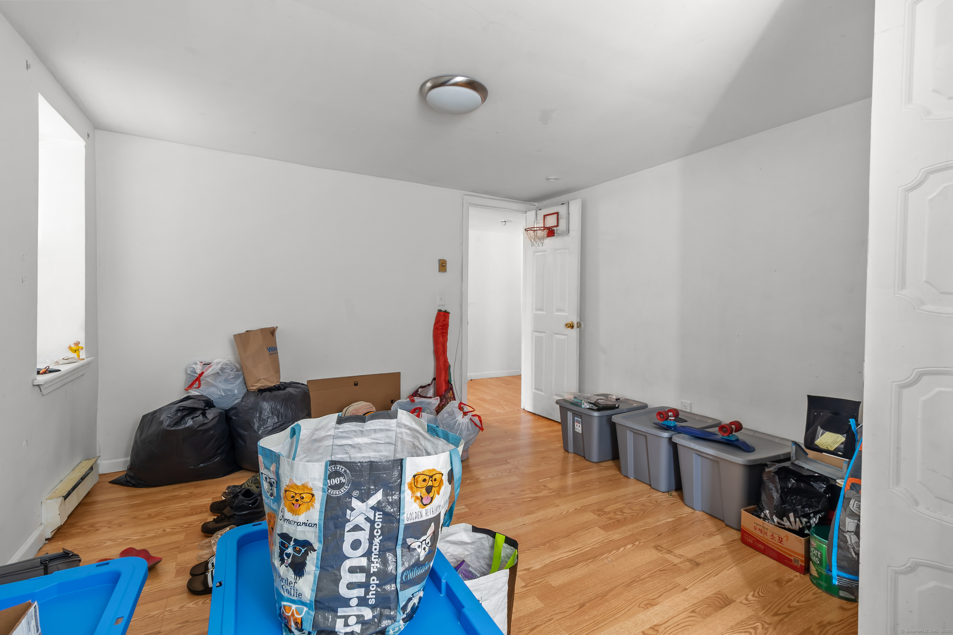 136 Washington Street Norwich, CT 06360 - Photo 33 of 40 a bed room with furniture and a wooden floor