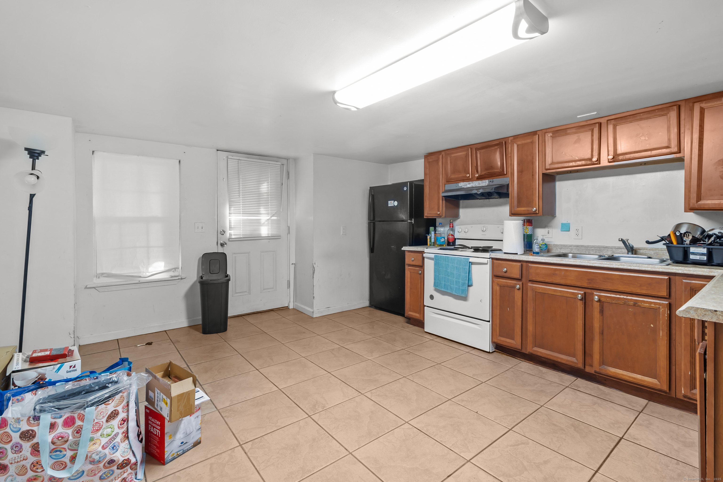 136 Washington Street Norwich, CT 06360 - Photo 34 of 40 a kitchen with stainless steel appliances granite countertop a refrigerator sink and cabinets