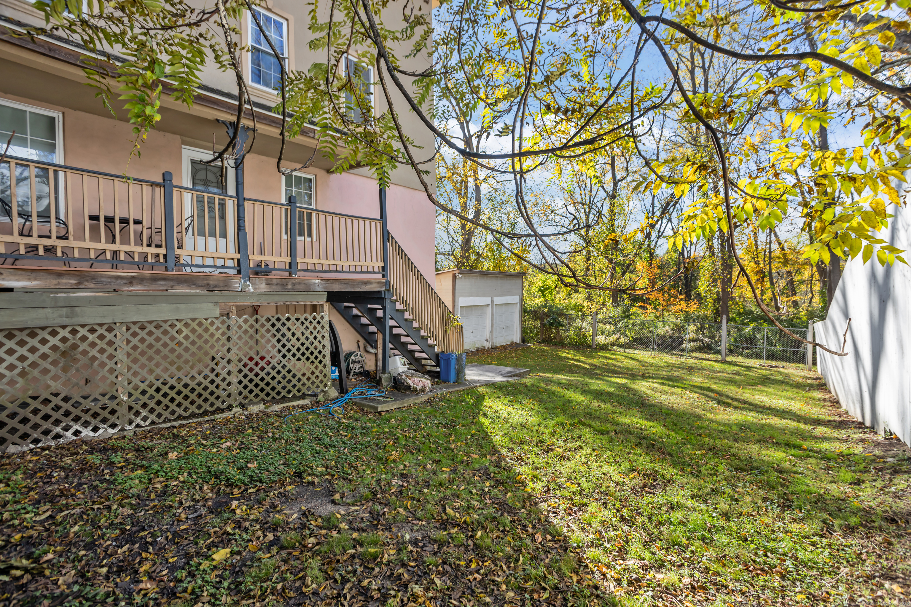136 Washington Street Norwich, CT 06360 - Photo 39 of 40 a view of a yard with plants and wooden fence