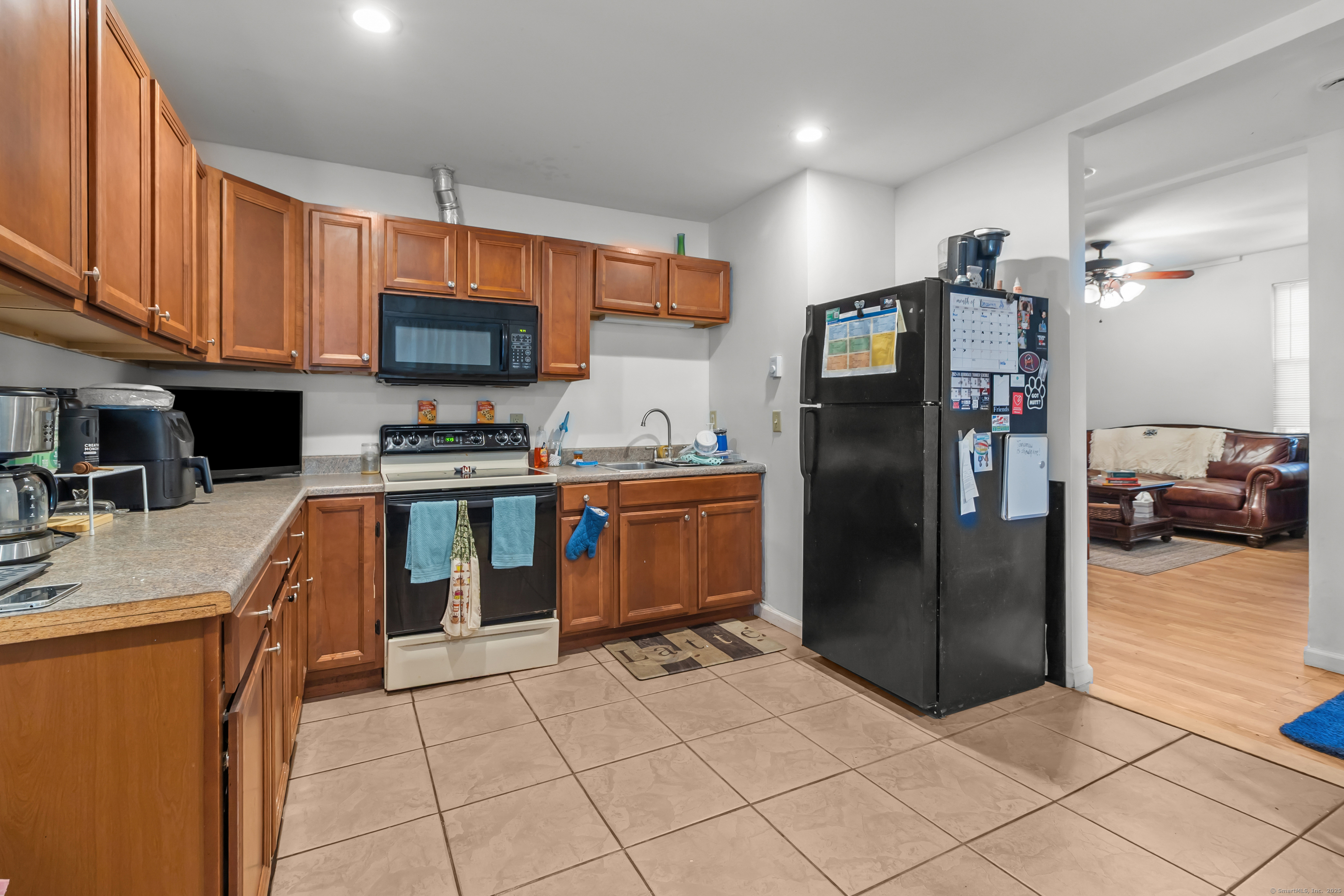 136 Washington Street Norwich, CT 06360 - Photo 5 of 40 a kitchen with stainless steel appliances granite countertop a refrigerator and a stove top oven