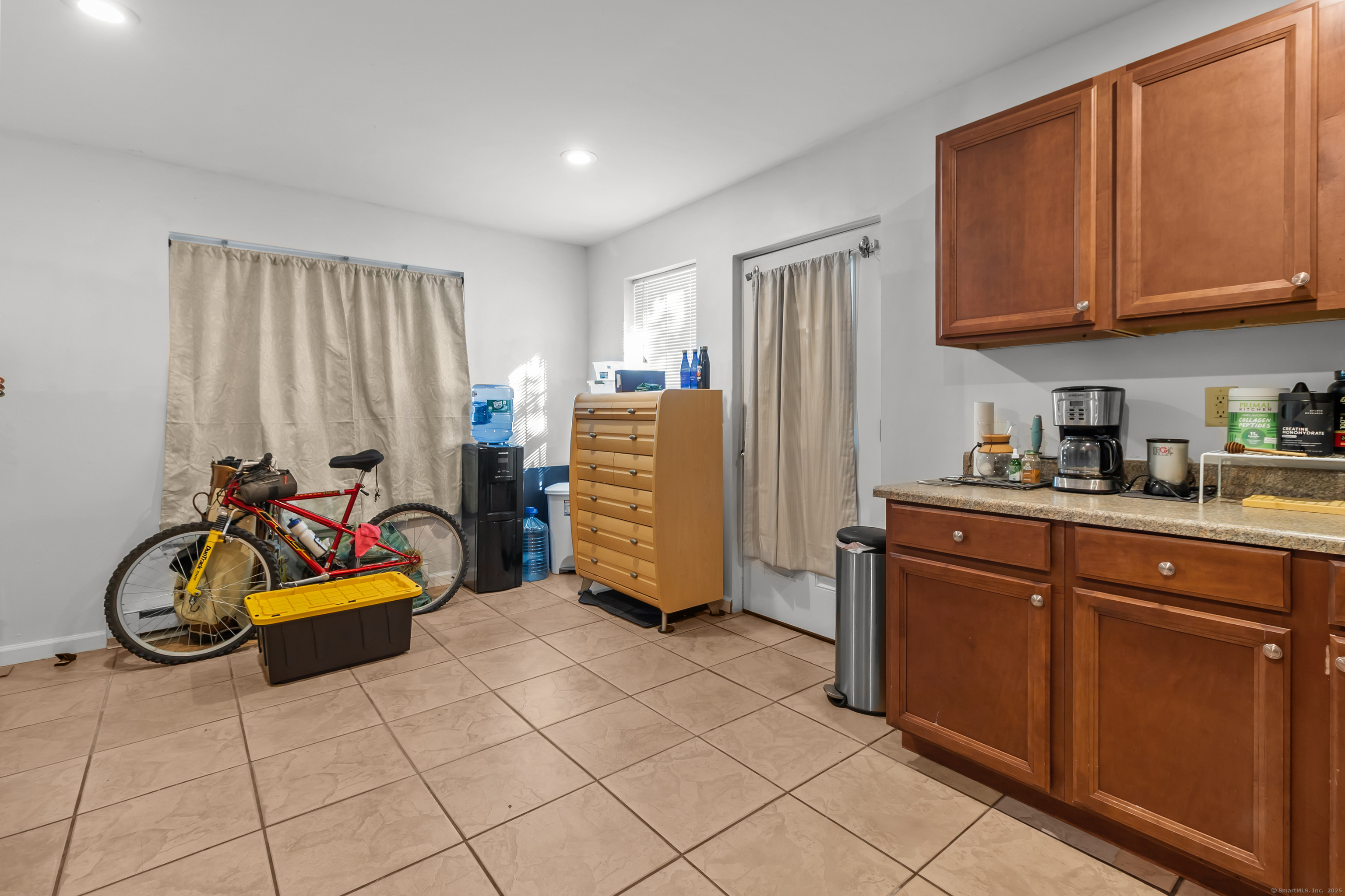 136 Washington Street Norwich, CT 06360 - Photo 6 of 40 a bedroom with a bed and gym equipment