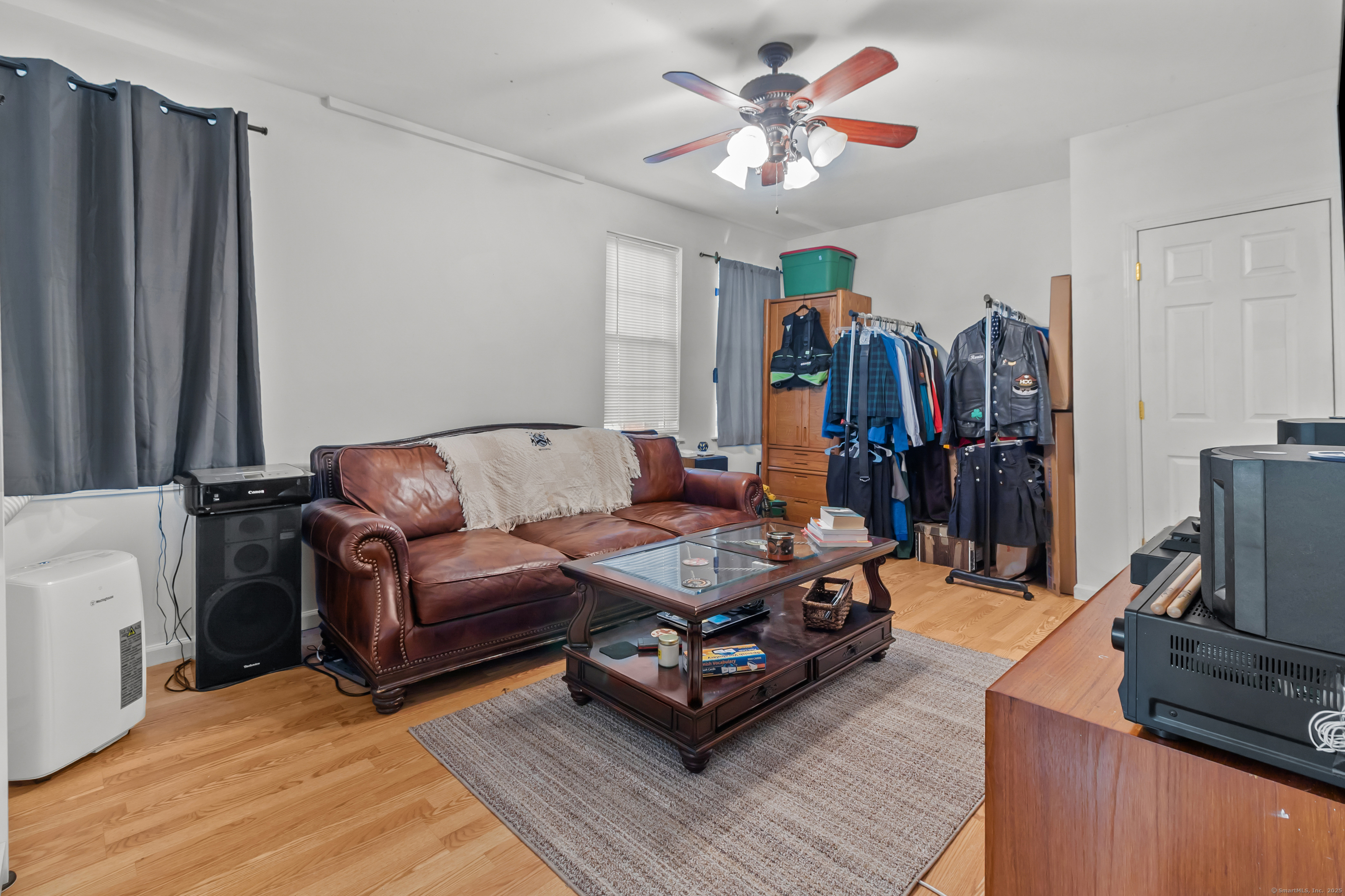 136 Washington Street Norwich, CT 06360 - Photo 8 of 40 a living room with furniture a flat screen tv and a window