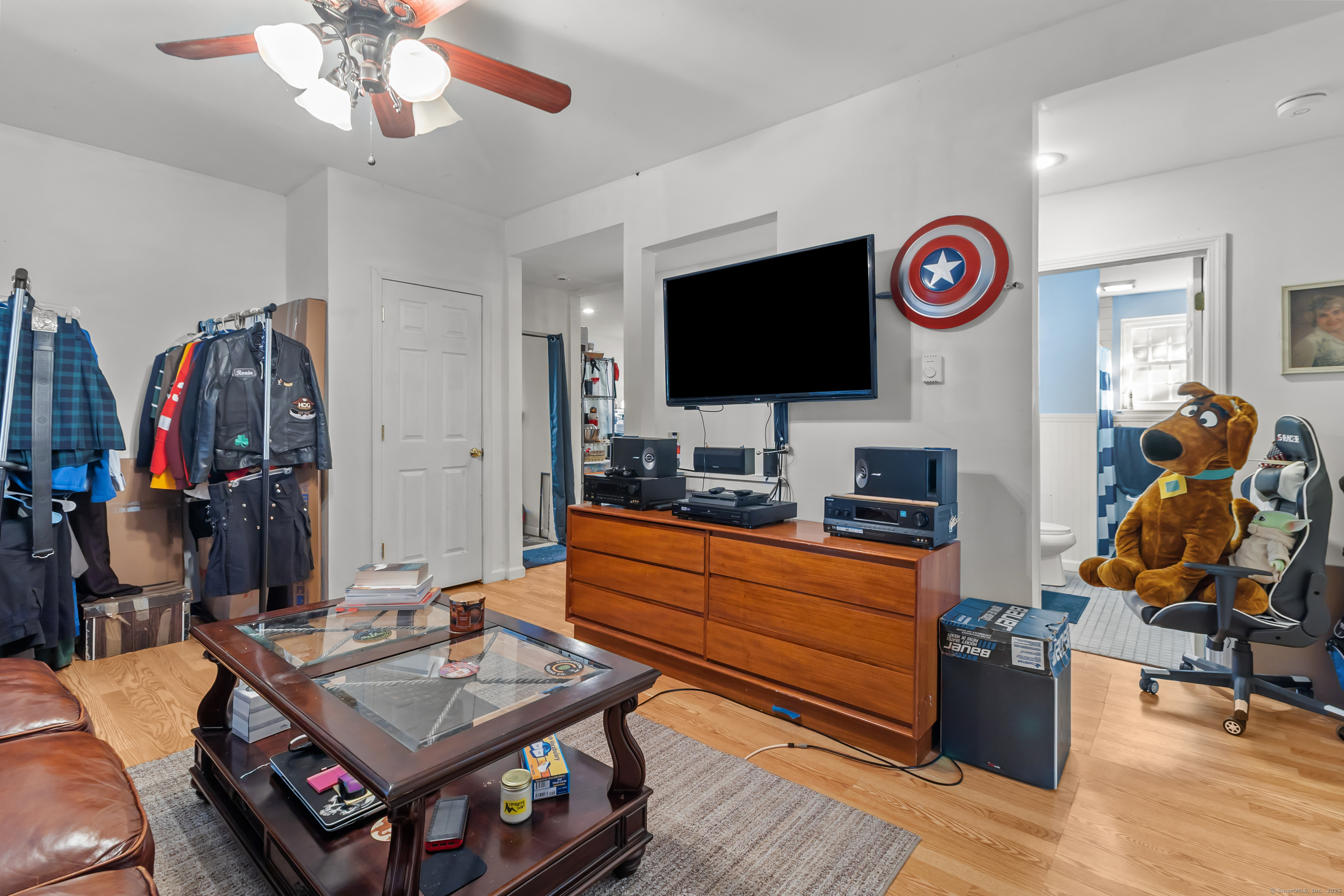 136 Washington Street Norwich, CT 06360 - Photo 9 of 40 a living room with furniture a flat screen tv and kitchen view