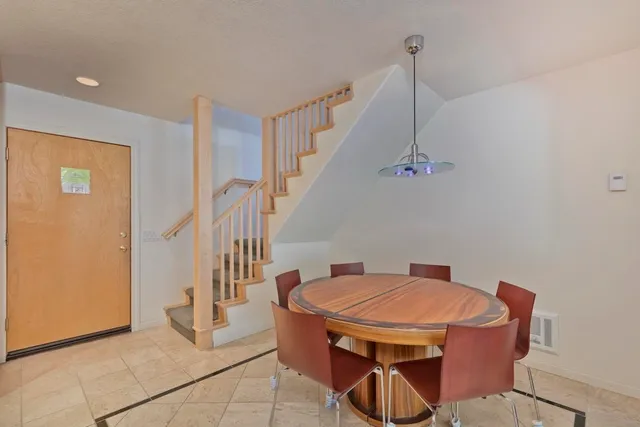 a dining room with furniture and wooden floor