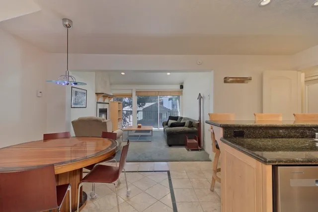 a living room with granite countertop furniture and a wooden floor