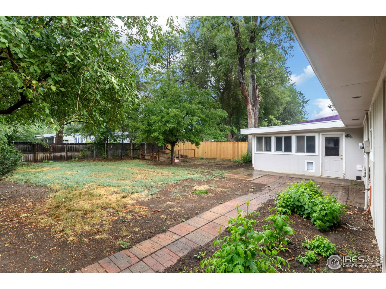 535 South Taft Hill Road Fort Collins, CO 80521 - Photo 19 of 26 Large fenced backyard with garden beds and partially new fence