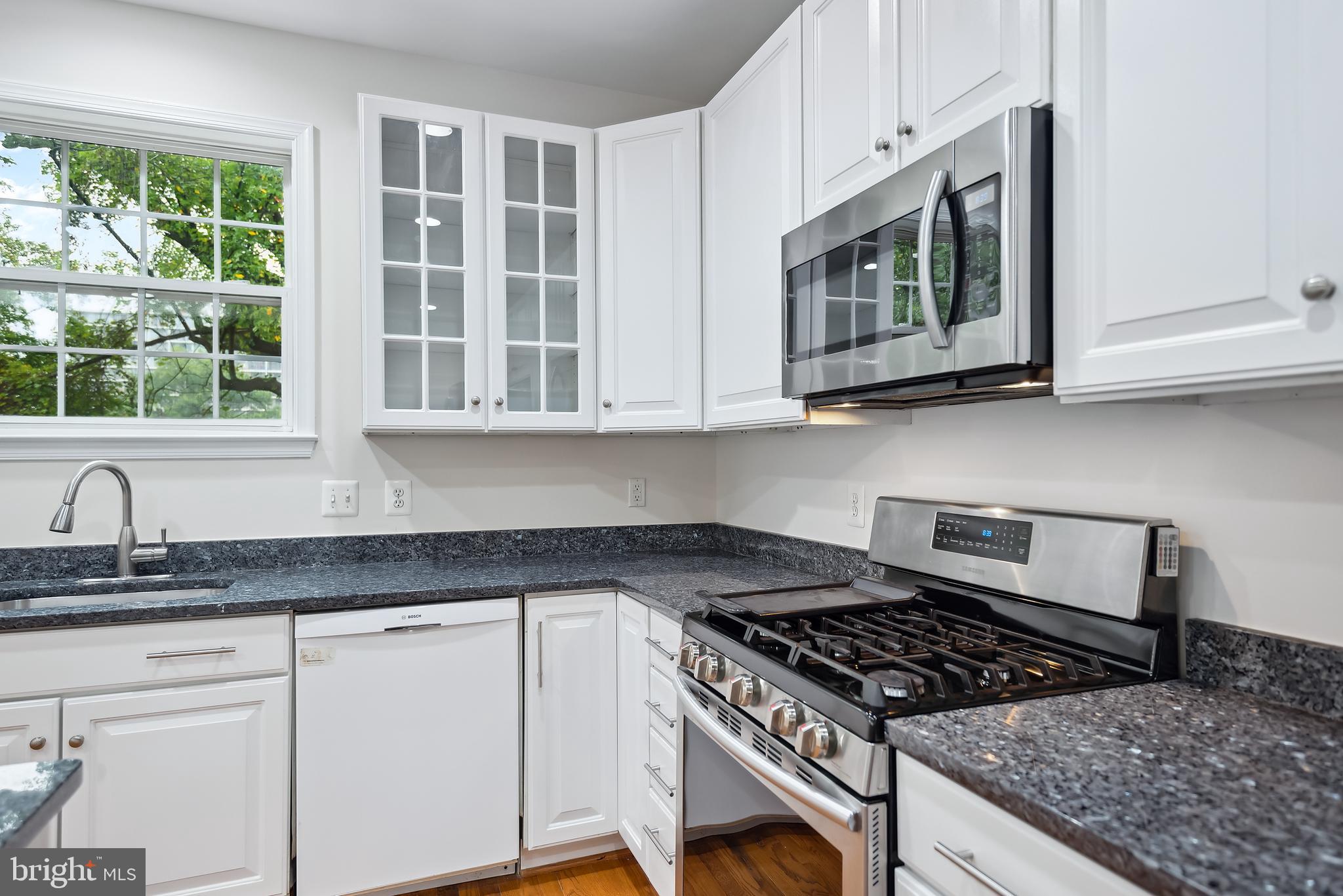 3303 Decatur Avenue Kensington, MD 20895 - Photo 32 of 94 Tall White cabinets Micowave above Gas Range