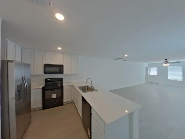 a front view of a house with a garden and yard