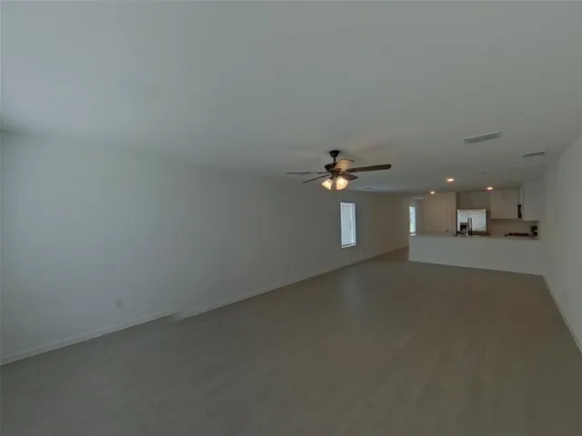 a kitchen that has a sink a refrigerator and cabinets