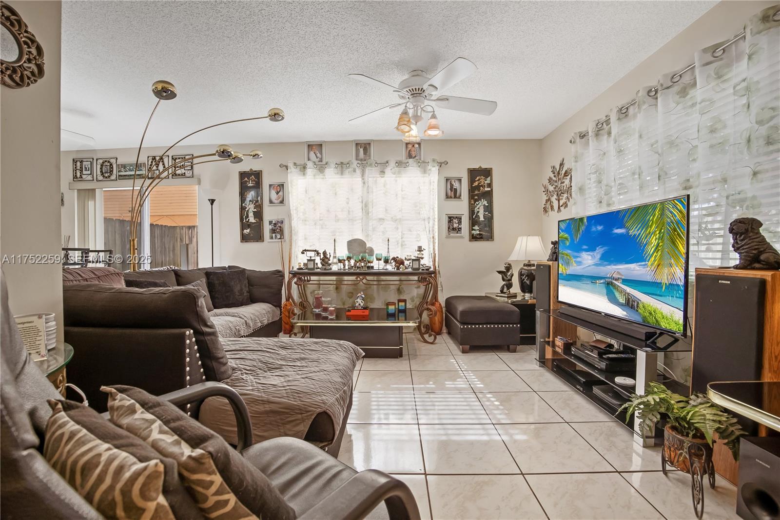 265 Northeast 12th Avenue, Unit 265 Homestead, FL 33030 - Photo 3 of 21 a living room with furniture and a flat screen tv
