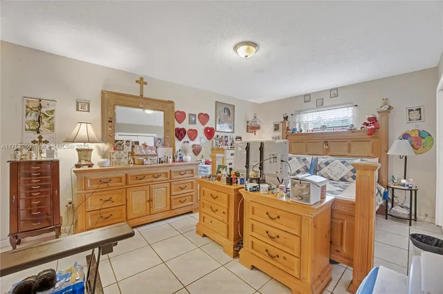 a kitchen with stainless steel appliances kitchen island granite countertop a refrigerator and sink