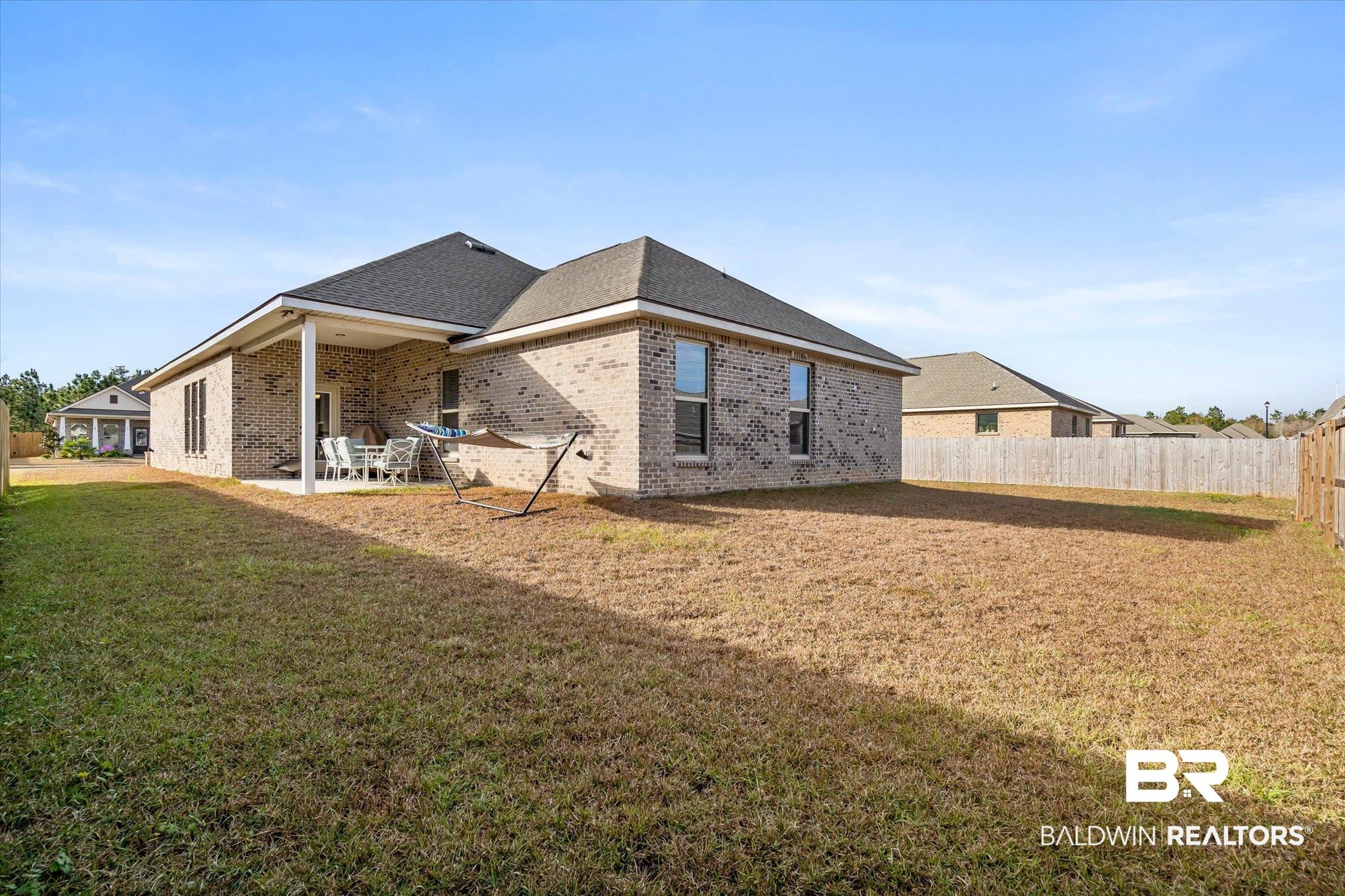 1116 Stella Road Foley, AL 36535 - Photo 25 of 29 Back of property featuring a yard and a patio