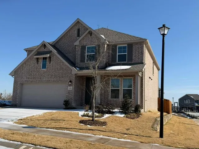 a front view of a house with yard and windows