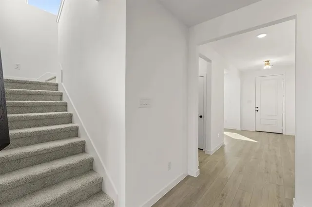 a view of an entryway with wooden floor