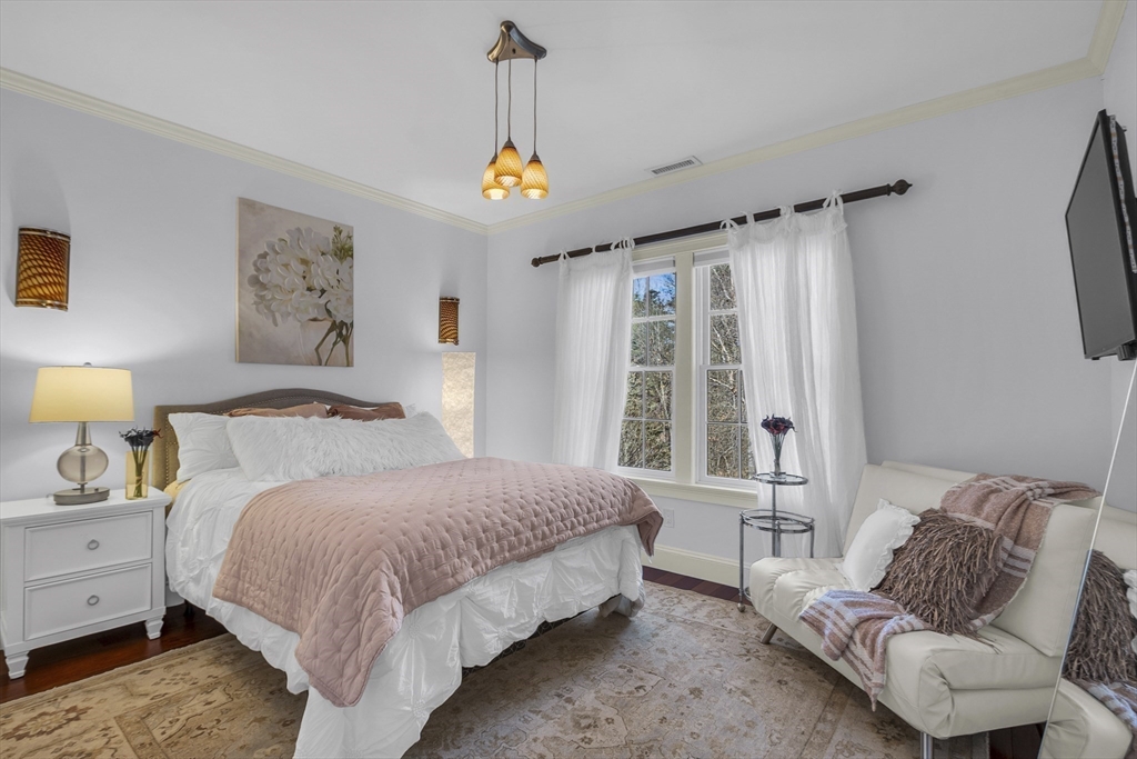 47 C Dana Road Boxford, MA 01921 - Photo 19 of 37 a spacious bedroom with a bed window and a flat screen tv