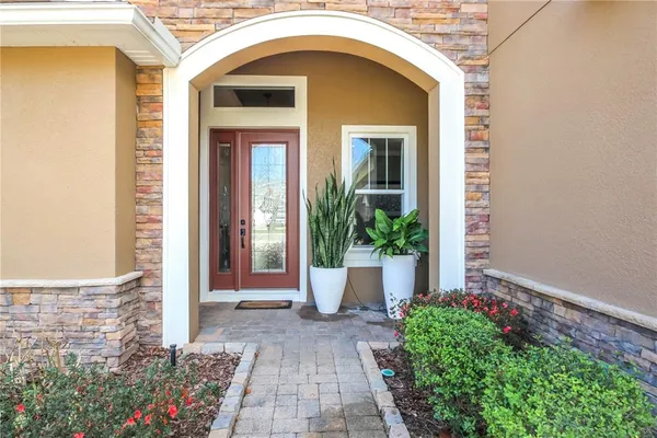 a front view of a house with potted plants