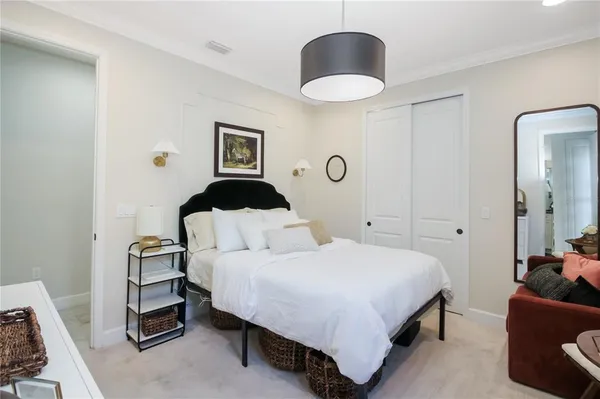 a bedroom with a bed and a chandelier