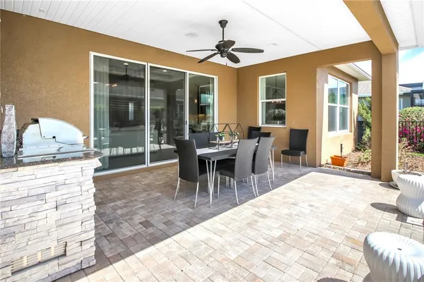 a view of a house with backyard and sitting area
