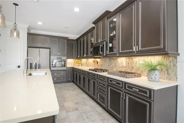 a kitchen with stainless steel appliances granite countertop a sink and cabinets