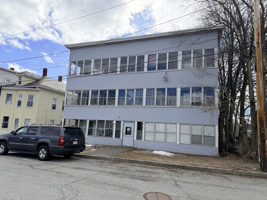 22 Knowlton Street, Unit 6 Gardner, MA 01440 - Photo 9 of 9 a car parked in front of a building