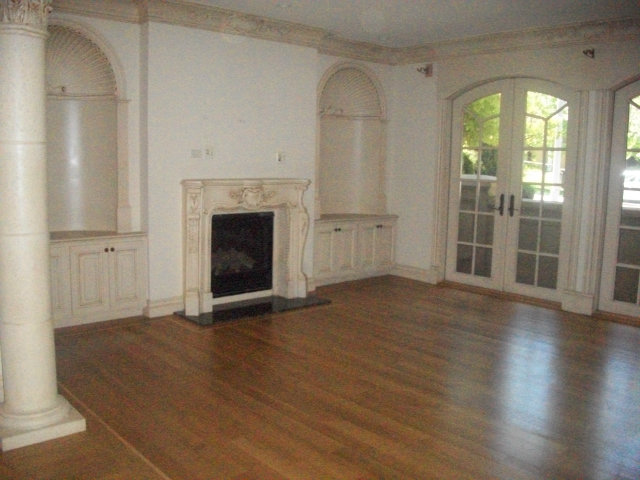 512 Primrose Road, Unit 102 Burlingame, CA 94010 - Photo 5 of 20 an empty room with wooden floor fireplace and windows