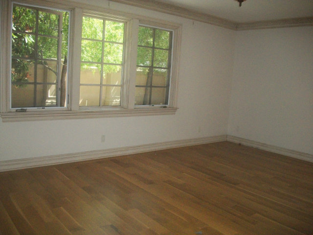 512 Primrose Road, Unit 102 Burlingame, CA 94010 - Photo 6 of 20 an empty room with wooden floor and windows
