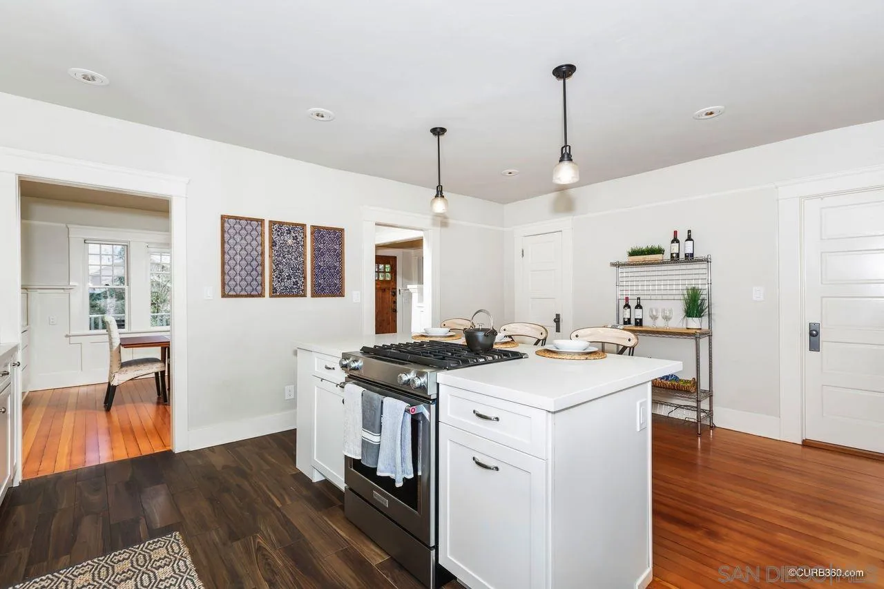 4112 Jackdaw Street San Diego, CA 92103 - Photo 11 of 34 a kitchen that has a sink a stove and wooden floor