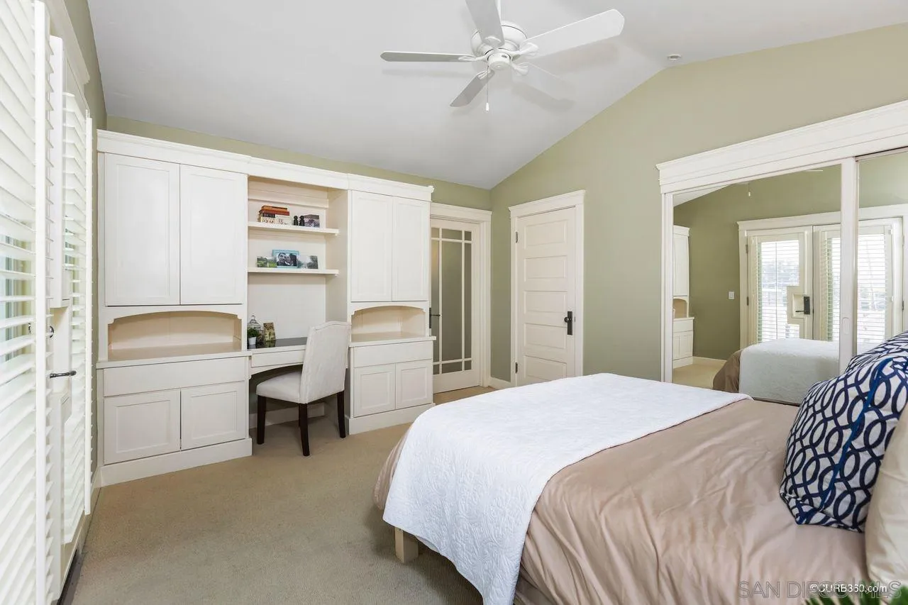 4112 Jackdaw Street San Diego, CA 92103 - Photo 16 of 34 a bedroom with a bed and a chandelier