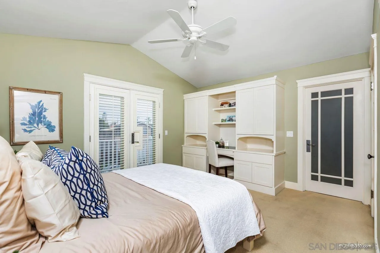 4112 Jackdaw Street San Diego, CA 92103 - Photo 18 of 34 a bedroom with a large bed and a chandelier