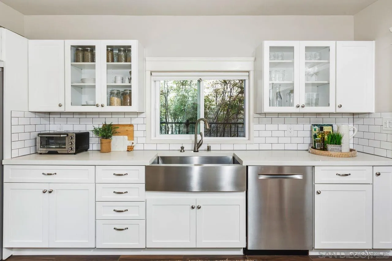 4112 Jackdaw Street San Diego, CA 92103 - Photo 6 of 34 a kitchen with granite countertop a sink and white cabinets