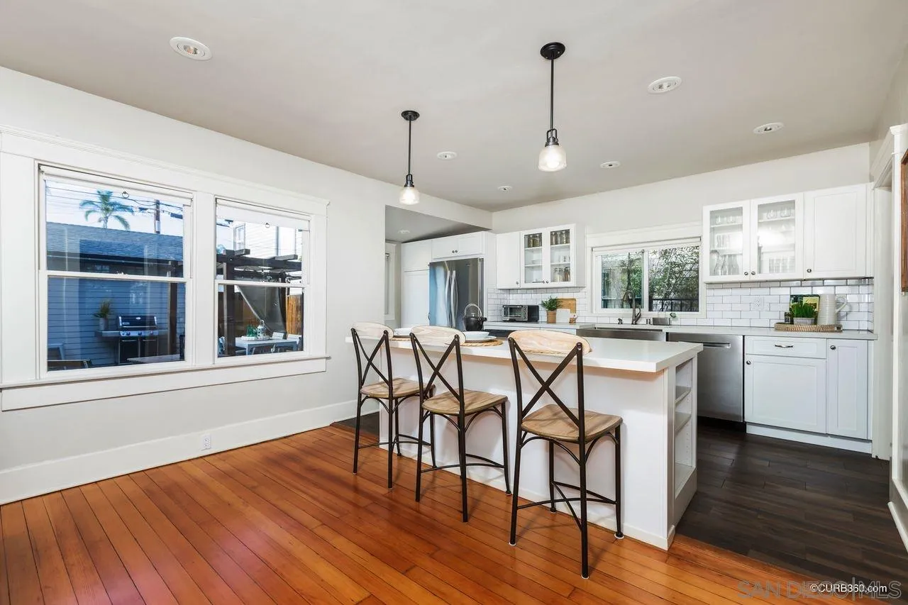 4112 Jackdaw Street San Diego, CA 92103 - Photo 7 of 34 a view of a dining room with furniture window and wooden floor