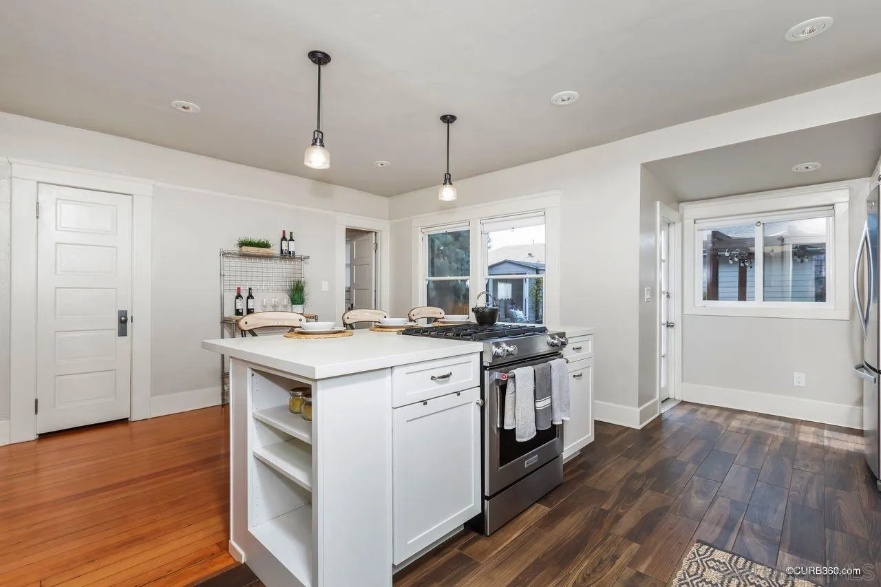 4112 Jackdaw Street San Diego, CA 92103 - Photo 8 of 34 a kitchen with a stove and a wooden floor