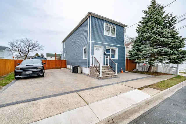 a house view with a car parked in front of it