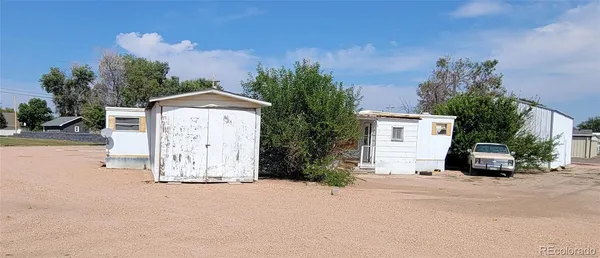 a view of a house with a yard and garage