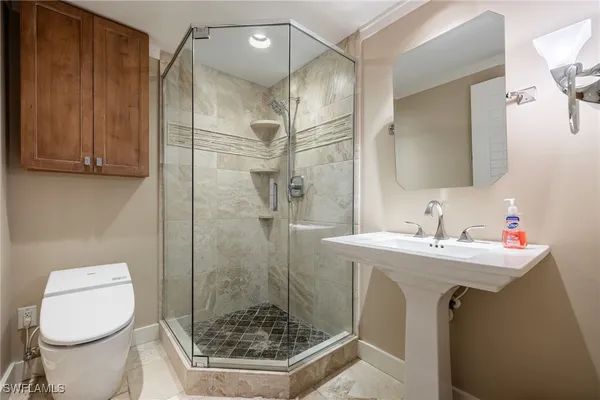 a bathroom with a sink toilet and shower