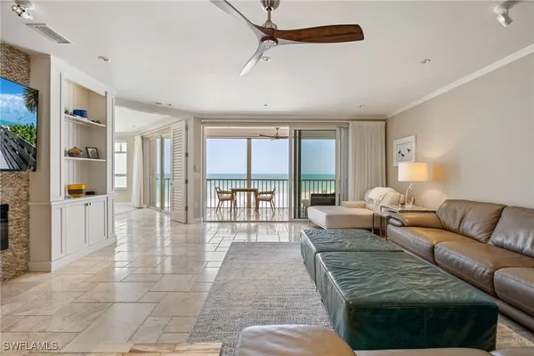 a living room with furniture and a floor to ceiling window