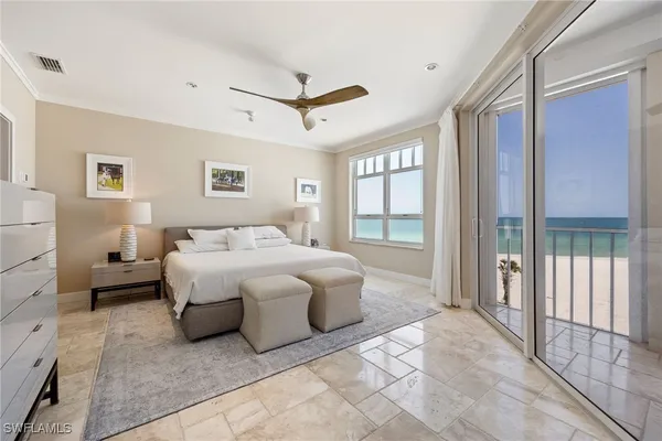 a spacious bedroom with a bed and glass door