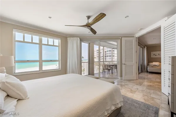 a bedroom with a large bed and a large window