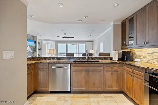 a kitchen with stainless steel appliances granite countertop a sink and cabinets