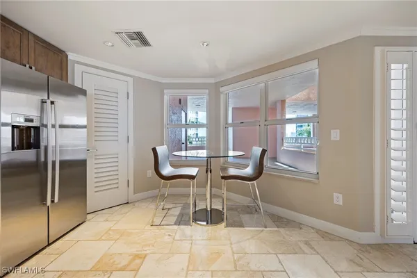 a dining room with furniture and a window