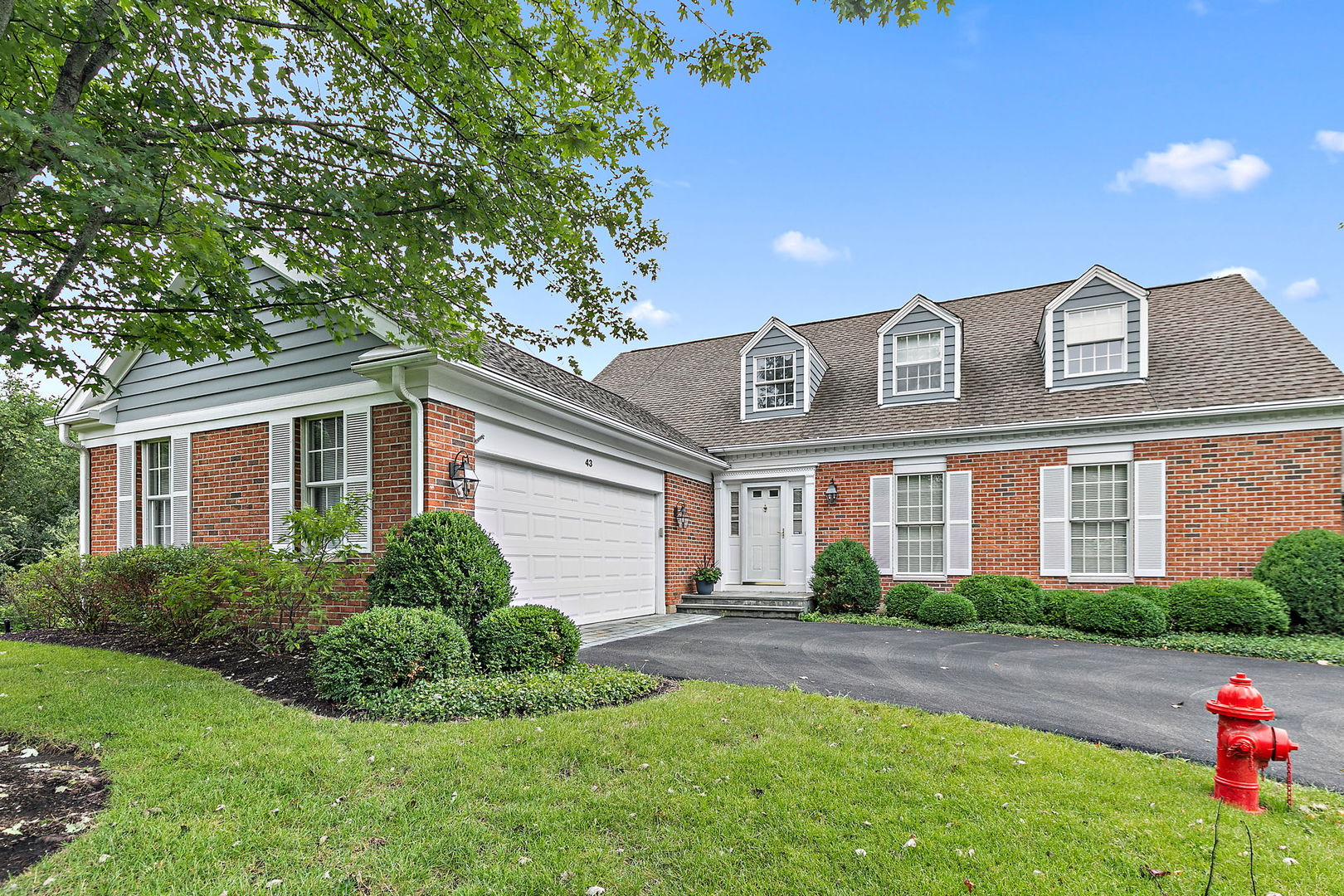 43 North Ravenscraig Lane Inverness, IL 60067 - Photo 1 of 67 a front view of a house with a yard and potted plants